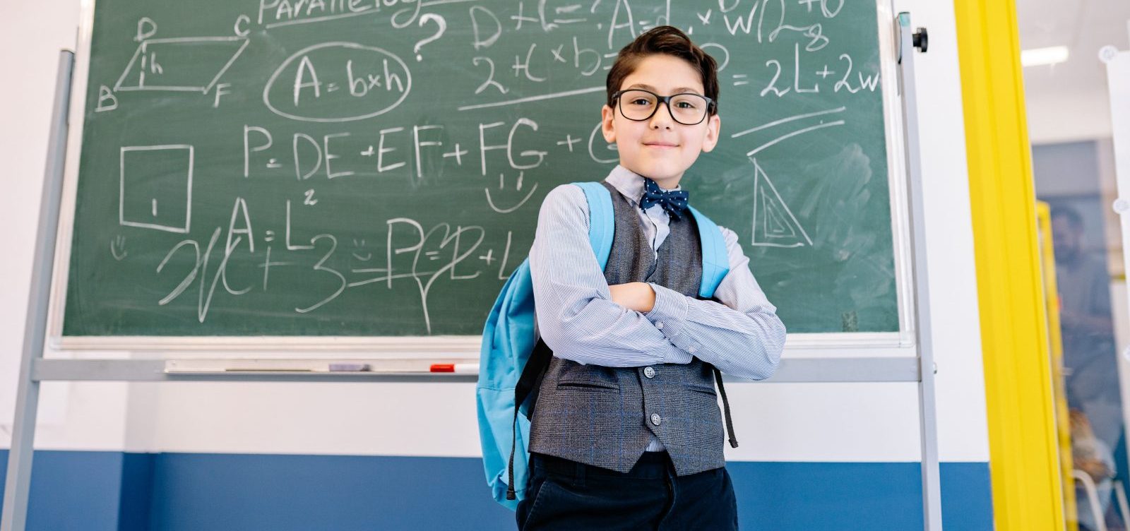 male-student-with-arms-crossed-inside-classroom-e1642019884684